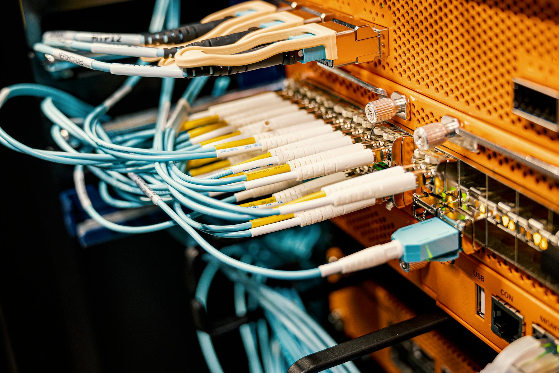 Close-up of structured fiber and copper cabling in a patch panel